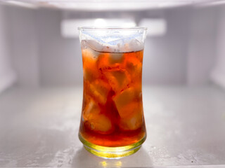 Asian food dishes peach iced tea in the refrigerator