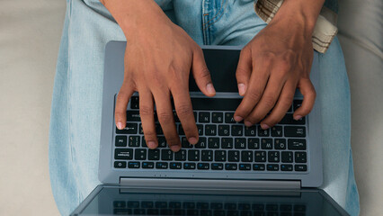 Top view moving shot unrecognizable African American woman work laptop man job online computer couple working at home couch sofa office two colleagues coworkers users typing two pc computers coworking