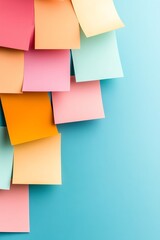 Fototapeta premium A vibrant arrangement of colorful sticky notes on a bright blue background, perfect for organization and creativity.