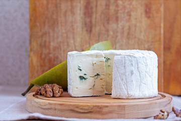 Blue cheese with walnuts on cutting board