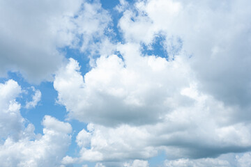 Serene blue canvas adorned with fluffy white clouds, a breathtaking celestial masterpiece