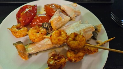 Grilled shrimp and vegetable skewers on a plate