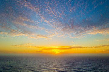 Dramatic sunset sky with clouds over the ocean