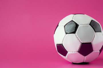 Soccer ball in pink on . game sport football concept. soccer ball lies on pink with a teddy bear and other sports. a soccer ball lies on a pink with a teddy bear playing sports lifestyle.