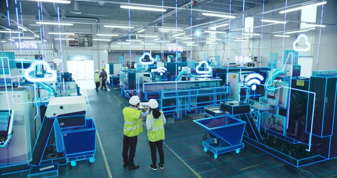 Factory Digitalization: Two Industrial Engineers Use Tablet Computer, Big Data Statistics Visualization, Optimization of High-Tech Electronics Facility. Industry Four Machinery Manufacturing Products