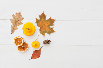 Autumn holiday frame composition with pattern made of leaf, punpkins, dried orange, pine cone on...