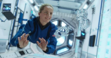 Female Cosmonaut in a Blue Suit Interacts With Floating Water Droplets Inside a Space Station, Capturing the Unique Behavior of Liquids in Microgravity. - Powered by Adobe