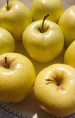 Yellow apples on a plate with background