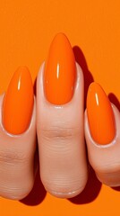 Vibrant Orange Nails on Orange Background: A Bold Beauty Statement