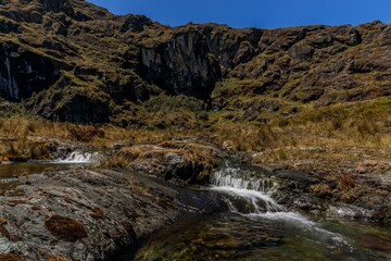 Mountain stream under clear blue sky
