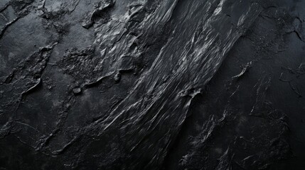 Abstract black textured surface with subtle grooves and patterns.