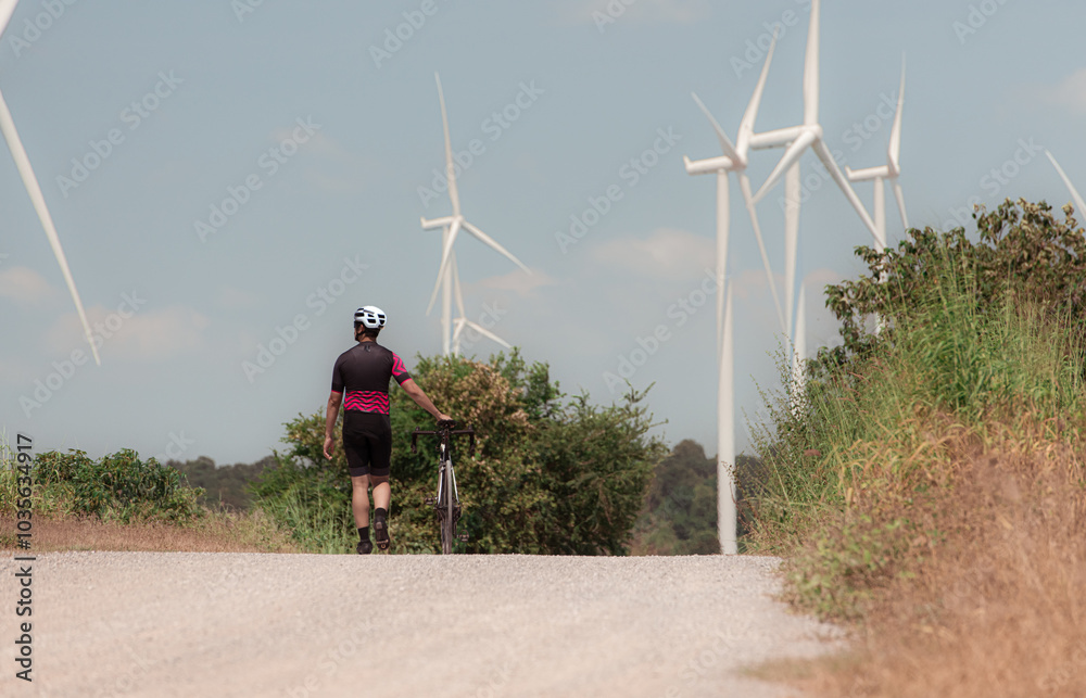 Wall mural cyclists are riding their bikes for training and touring the wind farms