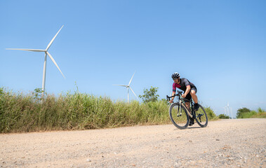 Cyclists are riding their bikes for training and touring the wind farms