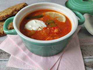 Traditional East German Soljanka Soup with Pickles, Leftover Sausage  and Sour Cream