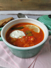 Traditional East German Soljanka Soup with Pickles, Leftover Sausage  and Sour Cream