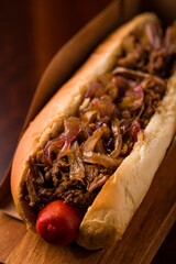 Delicious Gourmet Hot Dog with Caramelized Onions and Juicy Sausage