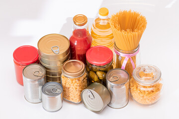 Food Reserves: Canned Food, Spaghetti, Pate, Tuna, Tomato Juice, Pasta, Fish and Grocery on White Background. Emergency Food Storage in Case of Crisis. Strategic Food Supplies