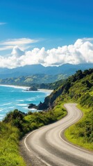 A scenic coastal road winds through lush greenery, offering breathtaking views of the ocean and mountains under a clear blue sky.