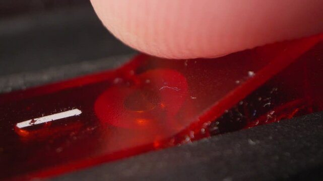 A finger presses the dusty red switch button and turns off the macro close-up light, running out of energy, reliance on others