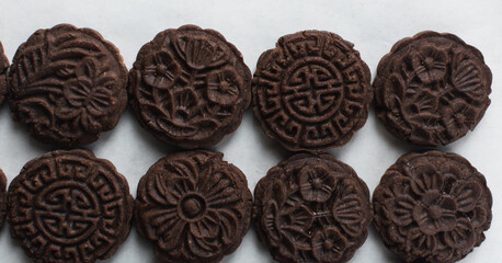 Overhead view of chocolate mooncake on a white background, top view of chocolate mooncake for lunar new year, top view of dessert mooncake 