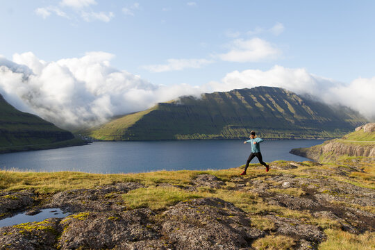 Trail runner running at fjord