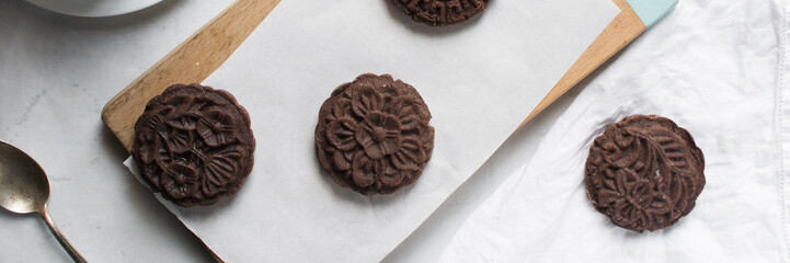 Overhead view of chocolate mooncake on a white background, top view of chocolate mooncake for lunar new year, top view of dessert mooncake 