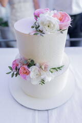 large three-tiered cake at a wedding with decor delicious beautiful