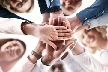 Below, business people or hand stack in office for trust, synergy or positive reinforcement....
