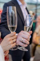 a man holds a glass of champagne in his hand at a celebration in a restaurant
