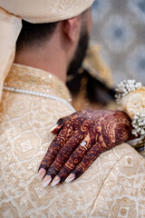 Indian henna mehndi on the hand of a South Asian bride.