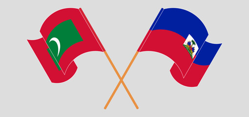 Crossed and waving flags of Maldives and Republic of Haiti. Vector illustration