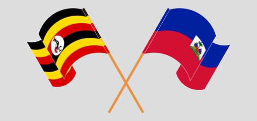 Crossed and waving flags of Uganda and Republic of Haiti. Vector illustration