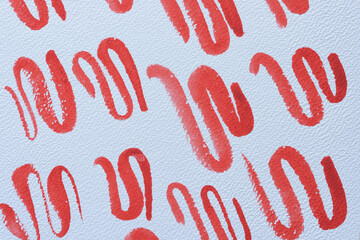 set of random squiggly red lines on textured paper