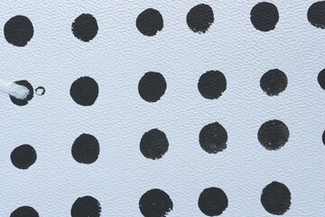 black dots on textured paper background
