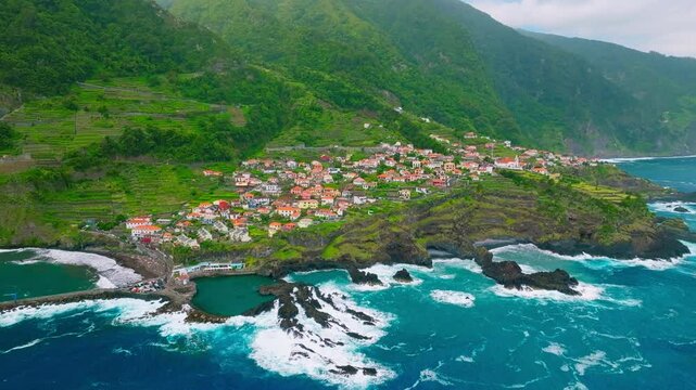 Aerial dron shot of Seixal village on Atlantic ocean coast on Madeira island, Portugal. Orbit parallax shot