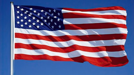 The American flag waves proudly in the wind against a bright blue sky, symbolizing freedom and patriotism.