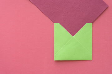 square green envelope and oversized red paper card on red