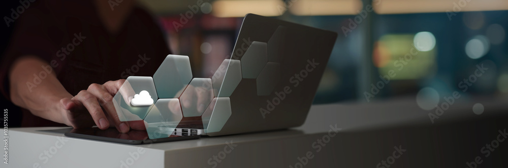 Fototapete A person is interacting with a laptop, where a virtual cloud icon is part of a hexagonal digital interface. modern technologycloud computing, emphasizing digital transformation and innovation. 