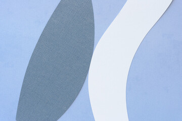 abstract background featuring textured and patterned cut blue and white paper