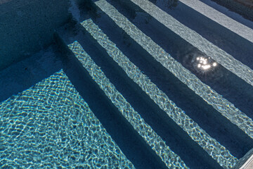 swimming poll stairs going into the watter