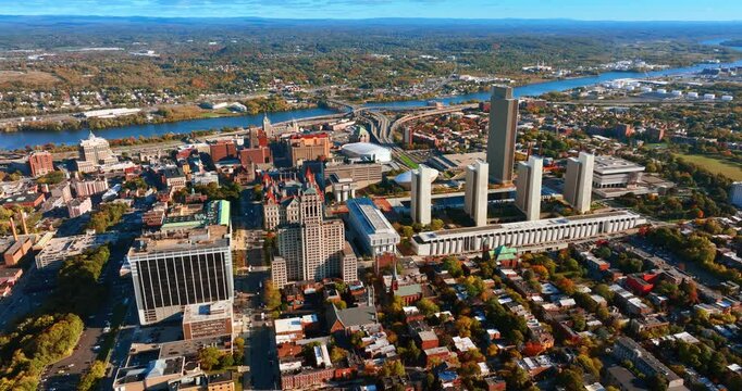Beautiful scenery of a bright city divided by the river into two parts. Autumn panorama of Albany, New York State, USA from birds' eye view.