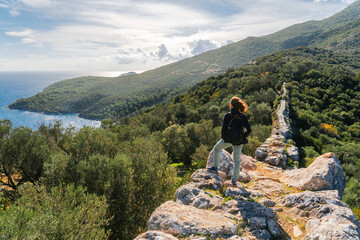 Young sport woman walking on Lycian Way in Turkey close to Kalkan town - sport outfit.