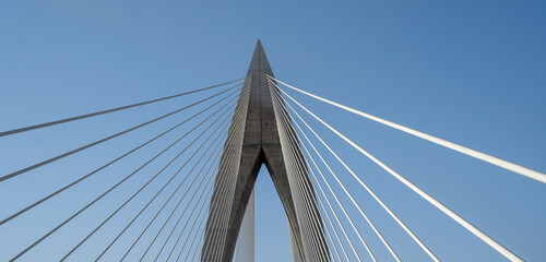 Obraz premium Detail of the Mohamed VI cable-stayed bridge over the Bouregreg river, or oued Bouregreg. Perfect blue sky.