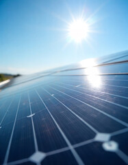 Close-up view of solar panels reflecting sunlight in a bright, clear sky during the afternoon at a renewable energy installation