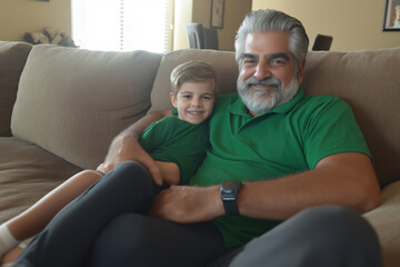 Obraz premium A joyful grandfather and grandson share a cozy moment on the couch at home