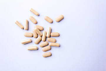 Ashwagandha (Withania somnifera) tablets and capsules on paper background. Soft focus.. Close up. Copy space.	