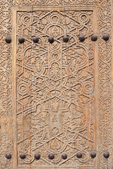 Old wooden carved door. Khiva. Uzbekistan