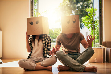 Playful, couple and cardboard with boxes on head for moving day, comedy renovation and property investment. People, funny drawing and new house with future security, comic celebration and emoji game