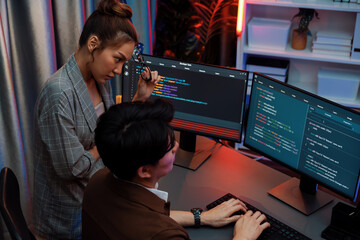 IT developers discussing with point to intelligent website development coder system running data...