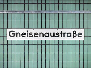 Gneisenaustraße sign at the underground train station in Berlin Kreuzberg, Germany. Location name...